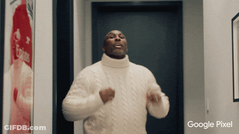 A Man In A White Sweater Is Dancing In Front Of A Google Pixel Ad GIF