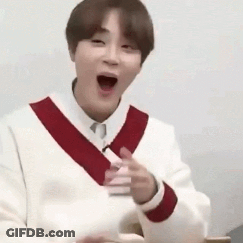 A Man In A White Sweater With A Red Stripe On The Sleeves Is Making A Funny Face With His Mouth Open . GIF