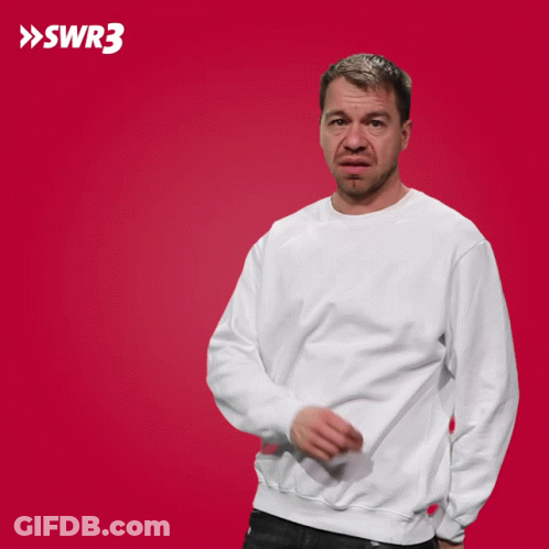 A Man In A White Sweatshirt Is Pointing At Something In Front Of A Red Background With The Letters Swr3 On It GIF