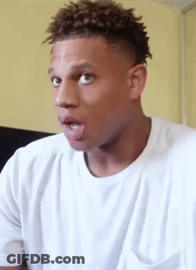 A Man In A White T-Shirt Is Sticking His Tongue Out GIF