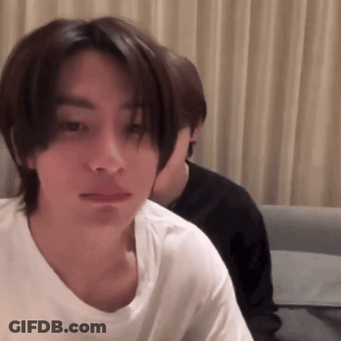 Man In White T-Shirt Looking At Camera GIF
