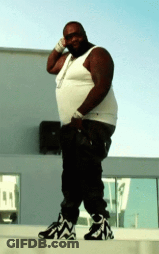 A Man In A White Tank Top And Black Pants GIF