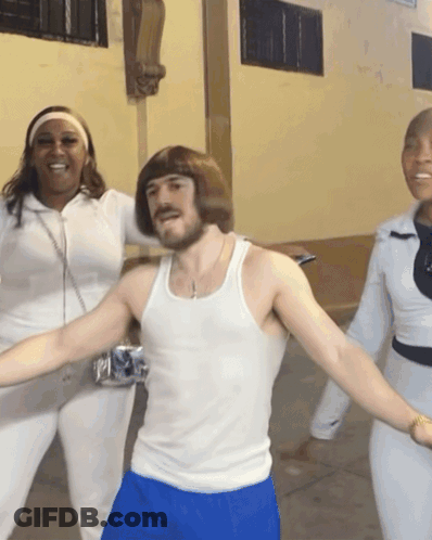 A Man In A White Tank Top And Blue Shorts Holds A Can Of Bud Light GIF