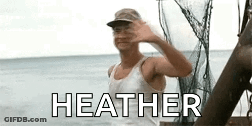 A Man In A White Tank Top And Hat Is Waving At The Camera While Standing On A Boat In The Ocean . GIF