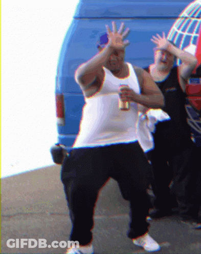A Man In A White Tank Top Holds A Can Of Beer GIF