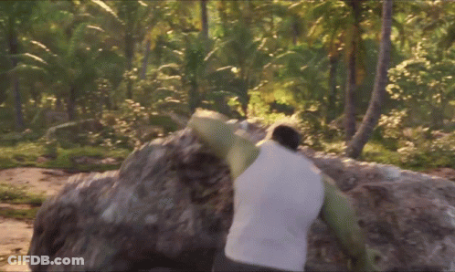A Man In A White Tank Top Holds A Large Rock On His Shoulders GIF