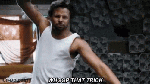 A Man In A White Tank Top Is Dancing With His Arms Outstretched And Saying Whoop That Trick . GIF