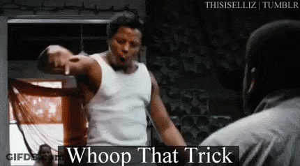 A Man In A White Tank Top Is Pointing At Another Man In A Boxing Ring And Saying `` Whoop That Trick '' . GIF