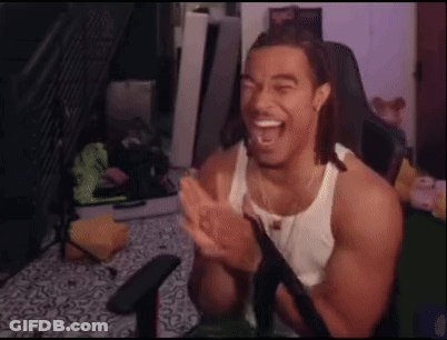 A Man In A White Tank Top Is Sitting In A Chair And Clapping His Hands . GIF