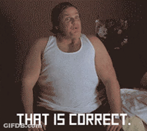 A Man In A White Tank Top Is Sitting On A Bed With The Words That Is Correct Above Him GIF
