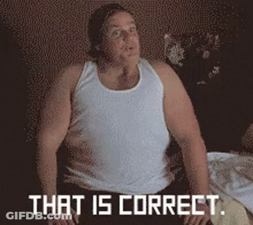 A Man In A White Tank Top Is Sitting On A Bed With The Words That Is Correct Behind Him GIF