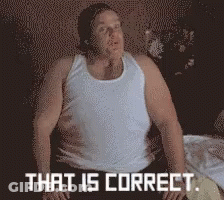 A Man In A White Tank Top Is Sitting On A Bed With The Words That Is Correct Behind Him GIF