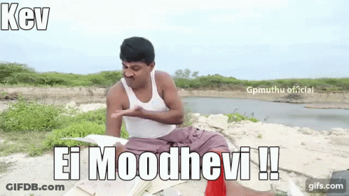 A Man In A White Tank Top Is Sitting On The Ground In Front Of A Body Of Water And Holding A Book . GIF