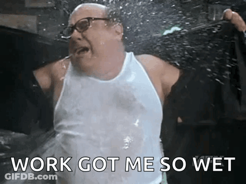 A Man In A White Tank Top Is Splashing Water On Himself . GIF