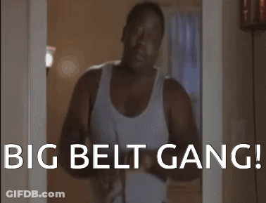 A Man In A White Tank Top Is Standing In A Doorway With The Words " Big Belt Gang " On The Bottom GIF