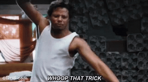 A Man In A White Tank Top Is Standing In A Room With His Arms Outstretched And Saying `` Whoop That Trick '' . GIF
