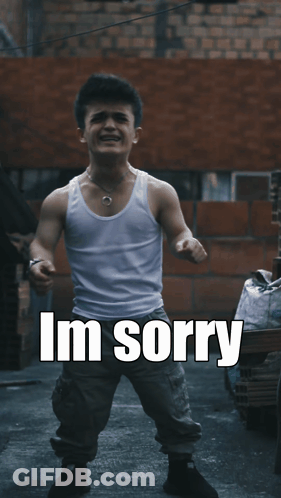 A Man In A White Tank Top Is Standing In Front Of A Brick Wall With The Words " Dont Leave Me " Above Him GIF