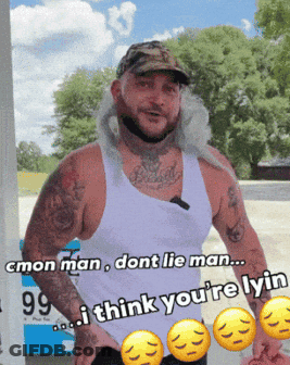 A Man In A White Tank Top Is Standing In Front Of A Gas Pump That Says 99 Cents GIF
