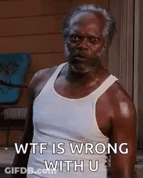 A Man In A White Tank Top Is Standing In Front Of A Window . GIF