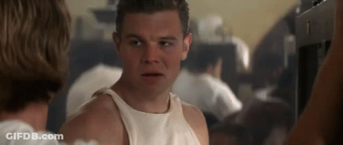 A Man In A White Tank Top Is Talking To A Woman . GIF