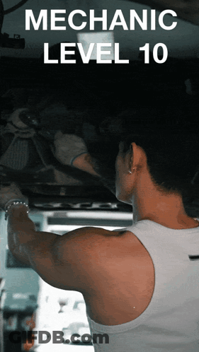 A Man In A White Tank Top Is Working Underneath A Car With The Words Mechanic Level 10 Behind Him GIF