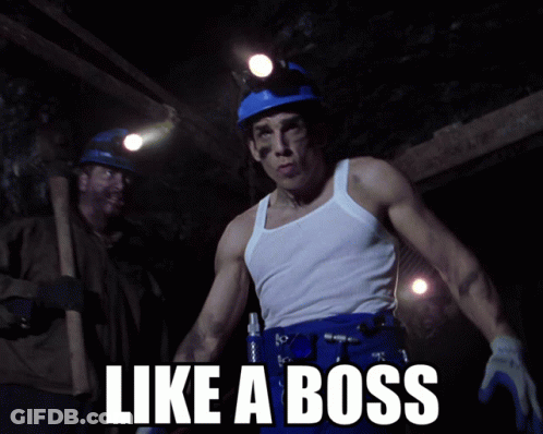 A Man In A White Tank Top Stands In A Cave With The Words Like A Boss Written Below Him GIF
