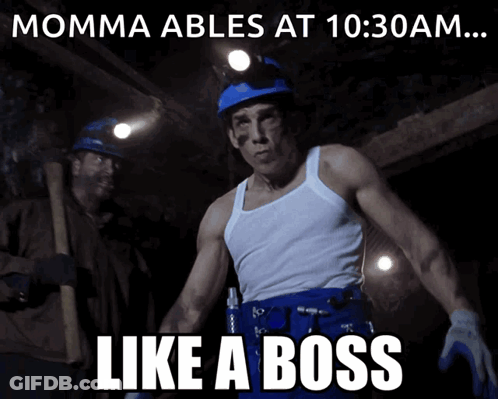A Man In A White Tank Top Stands In Front Of A Sign That Says " Momma Ables At 10:30 Am ... Like A Boss " GIF