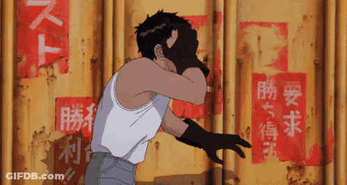 A Man In A White Tank Top Stands In Front Of A Yellow Wall With Chinese Writing On It GIF