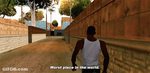 A Man In A White Tank Top Walks Down A Street With The Words Worst Place In The World Above Him GIF