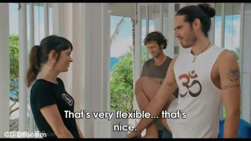 A Man In A White Tank Top With The Number 35 On It Is Talking To A Woman GIF