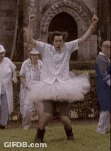 A Man In A White Tutu Is Dancing In A Park GIF
