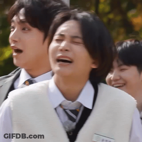 A Man In A White Vest And Tie Is Laughing GIF