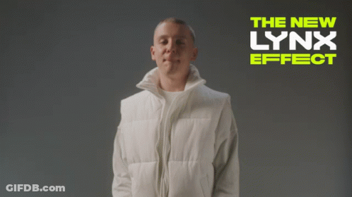 A Man In A White Vest Is Standing In Front Of A Banner That Says The New Lynx Effect GIF