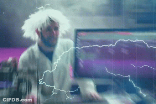A Man In A White Wig Is Standing In Front Of A Computer Screen With Lightning Coming Out Of It GIF