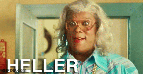 A Man In A Wig And Glasses Is Standing In Front Of A Door And The Word Heller Is On The Bottom GIF