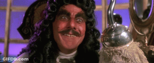 A Man In A Wig And Mustache Is Smiling And Holding A Hook . GIF