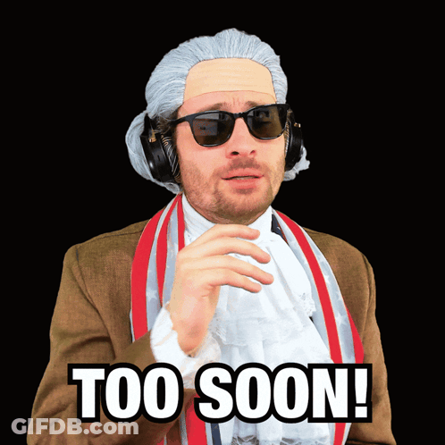A Man In A Wig And Sunglasses Has The Words Too Soon Written On His Face GIF