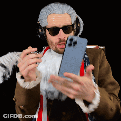 A Man In A Wig And Sunglasses Is Holding A Phone GIF