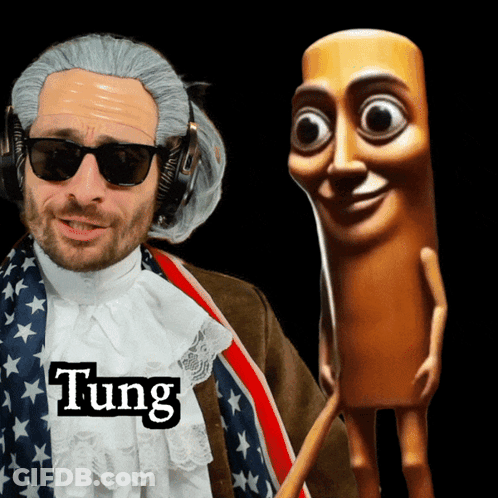 A Man In A Wig And Sunglasses Is Standing Next To A Wooden Stick With The Name Tung On It GIF