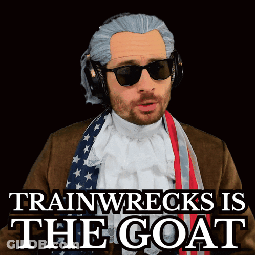 A Man In A Wig And Sunglasses With The Words Trainwrecks Is The Goat Below Him GIF