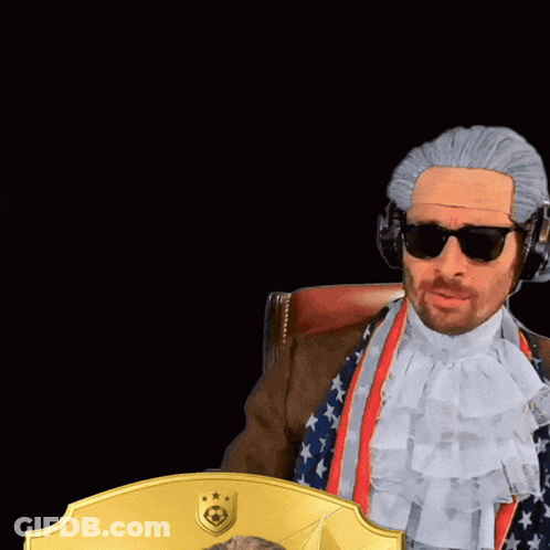 A Man In A Wig Is Holding A Card With The Number 99 GIF