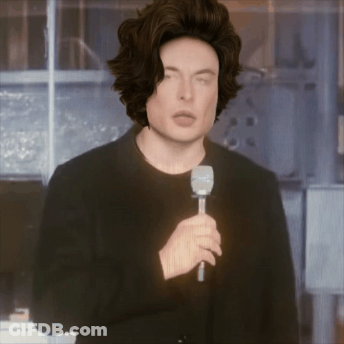 A Man In A Wig Is Holding A Microphone GIF