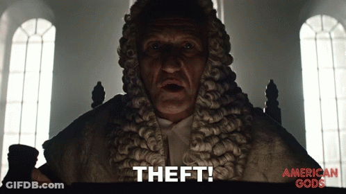 A Man In A Wig Says " Theft " In Front Of An American Gods Poster GIF