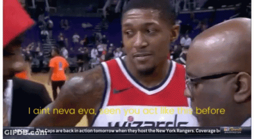 A Man In A Wizards Jersey Talks To A Man In A Suit GIF