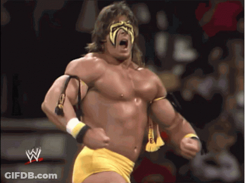 A Man In A Wrestling Outfit With The Letter W On The Bottom Right GIF