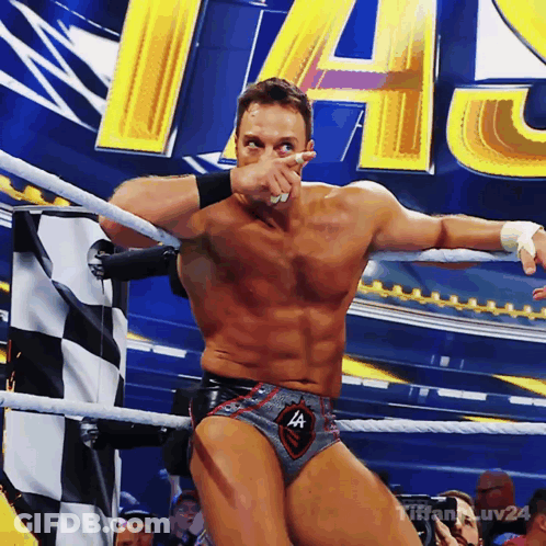 A Man In A Wrestling Ring Covering His Face With His Hand GIF