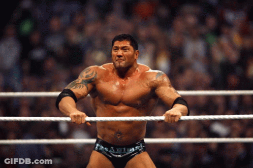 A Man In A Wrestling Ring Holds A Rope In His Hands GIF