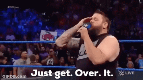 A Man In A Wrestling Ring Is Drinking From A Blue Cup . GIF