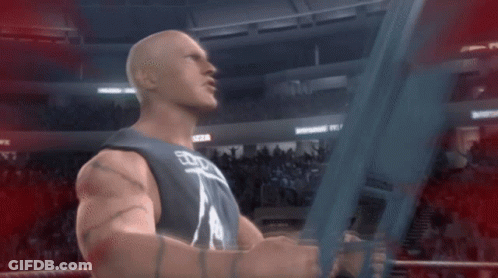 A Man In A Wrestling Ring Is Holding A Sword With The Word Wwe On It GIF