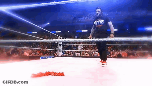 A Man In A Wrestling Ring Wearing A T-Shirt That Says Gtc GIF